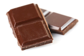Black chocolate pieces isolated on white background