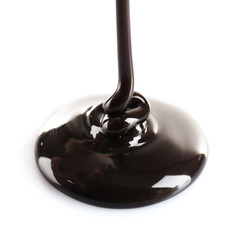 Melted black chocolate pouring, isolated on white