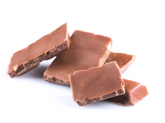 Milk chocolate pieces isolated on white