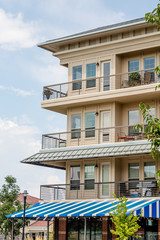 Blue and White Awning Under Condo Balconies