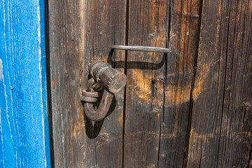 Old wooden door with old lock closed