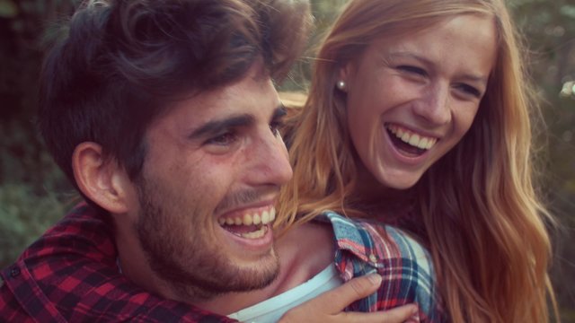 Handheld shot of couple having fun with piggyback ride
