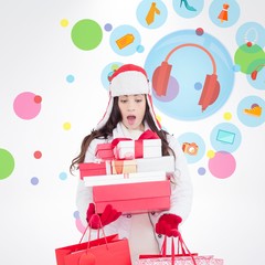 Surprised brunette in winter clothes holding gifts and bags