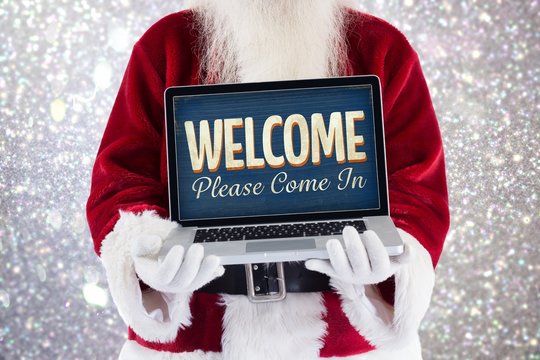 Composite image of santa claus presents a laptop