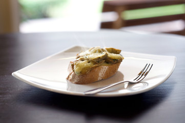 hot bruschetta mushrooms and cheese on bread with smoke