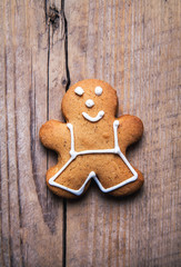 Christmas homemade gingerbread man on wooden table