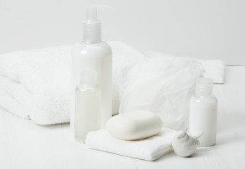Fototapeta na wymiar Shampoo, Soap Bar And Liquid. Toiletries, Spa Kit, Towels