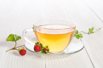 Cup of tea and strawbarries on the white wooden table