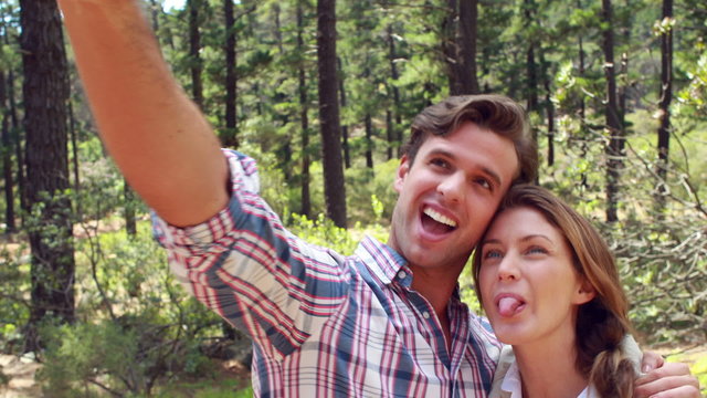 Smiling couple on a hike taking a selfie