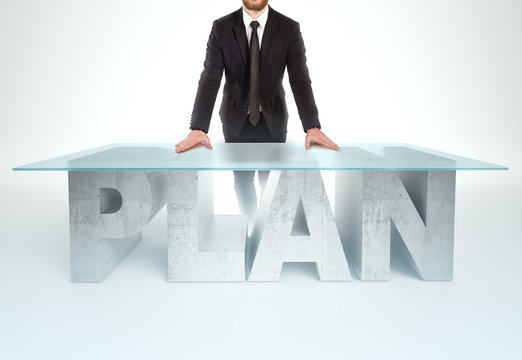 Confident business man leaning on PLAN table. Bussines concept