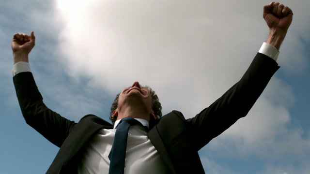 Handsome businessman put his hands up