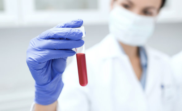 Close Up Of Scientist Holding Test Tube In Lab