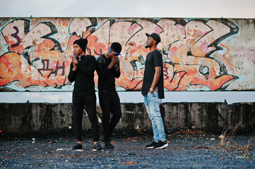 Three rap singers band on the roof background graffiti wall - obrazy, fototapety, plakaty