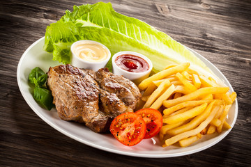 Grilled steak, French fries and vegetables 
