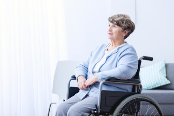 Disabled old woman on wheelchair