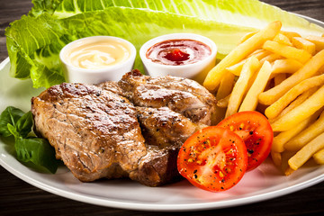 Grilled steak, French fries and vegetables 