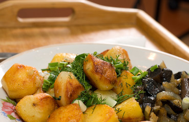 potatoes fried mushrooms  wood dish 