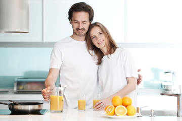 Couple with juice in the kitchen