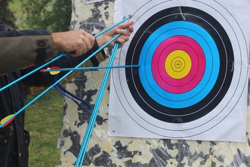 The man pulls the arrow from the target
