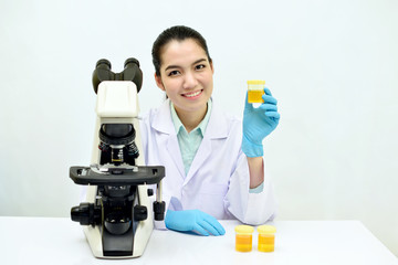 Medical technologist holding urine sample for analysis