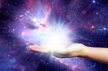 open female hand holding a powerful light - Elements of this image furnished by NASA