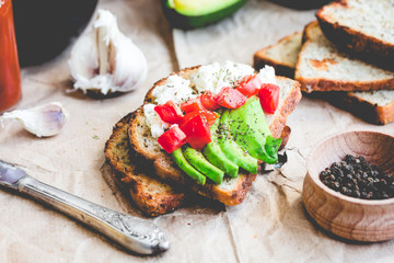 toast with fresh avocado, tomato and goat cheese, vegetarian sna