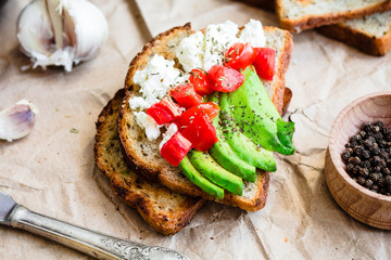 toast with fresh avocado, tomato and goat cheese, vegetarian sna