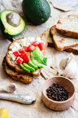 toast with fresh avocado, tomato and goat cheese, vegetarian sna