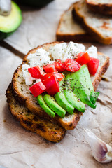 toast with fresh avocado, tomato and goat cheese, vegetarian sna