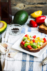 toast with fresh avocado, tomato and corn