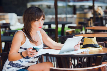 brunette woman sitting with tablet