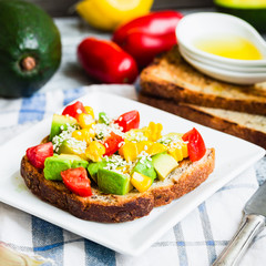 toast with fresh avocado, tomato and corn