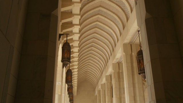 high colonnade with pointed arch at sultan quaboos mosque in muscat oman tilt down 4K UHD