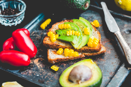 toast with fresh avocado and pepper, healthy snack, vegetarian f