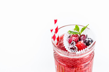 Top view of red cocktail with berries. White background. Appetizing delicious drink