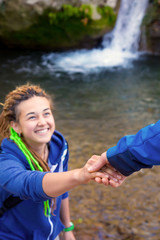 Naklejka premium Two Hikers young Man and Smiling Woman holding hands vertical