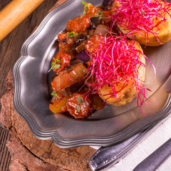 ratatouille with baked potato and beetroot sprouts