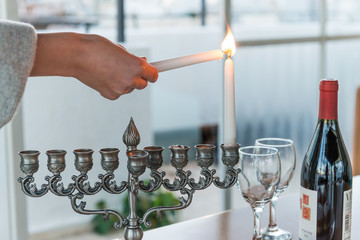 Lighting of candles for Hanukkah holiday. Hanukkah celebration attributes. Judaic holiday of lights.