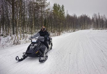 Man managing a snowmobile in Ruka in Lapland