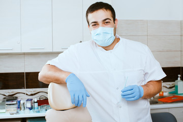 dentist leaning against dentists chair