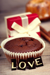 Chocolate muffin, gift box and word love