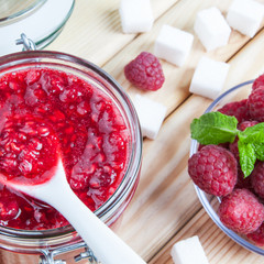 Raspberry jam on wooden table