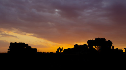 Back lit silhouettes on an orange sunset cloudscape