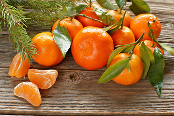 Mandarins with leaves , christmas tree on wooden background 