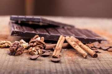 dark chocolate and cinnamon stick on wooden background
