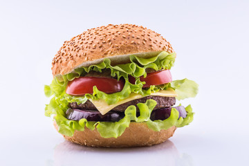 Big burger with beef cutlet and fresh vegetables isolated on white background