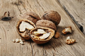 Fototapeta na wymiar Handful walnuts on the wooden table closeup