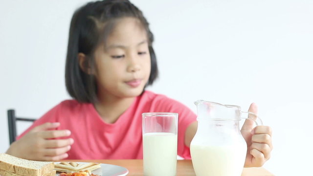 HD footage, dolly Asian girl eating breakfast on white 