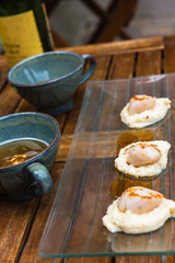 Close up of pan seared sea scallops and a cup of cider