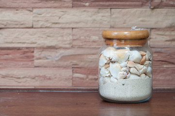 Jar with sand and shell